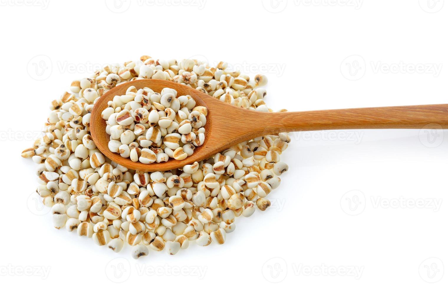 Millet in wood spoon isolated on white background photo