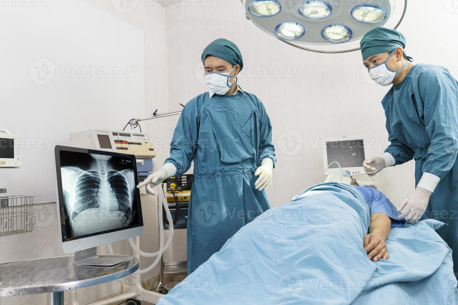 surgeon and assistant discussing together in the operating room. Surgery and emergency concept photo