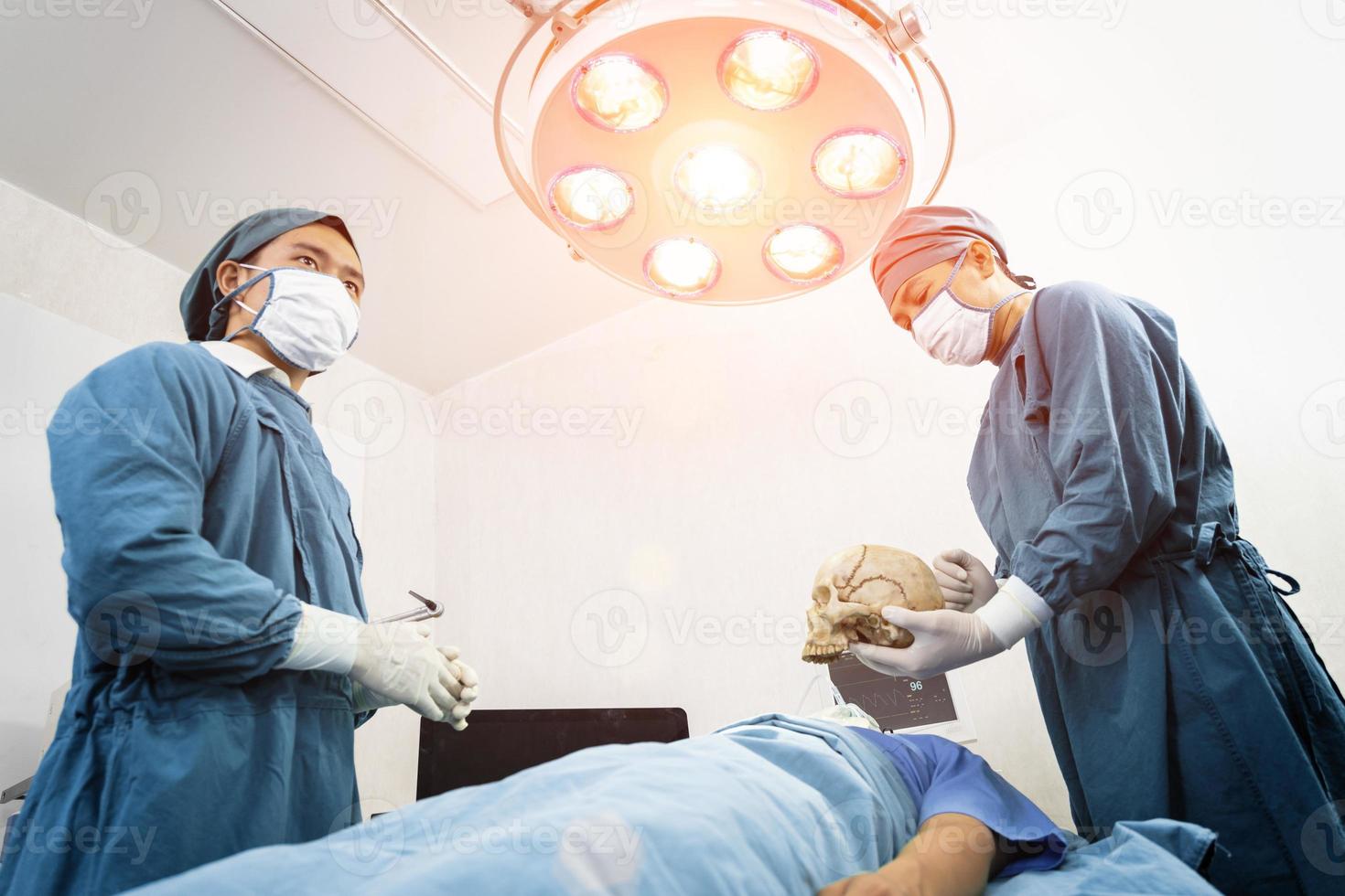 surgeon and assistant discussing together in the operating room. Surgery and emergency concept photo