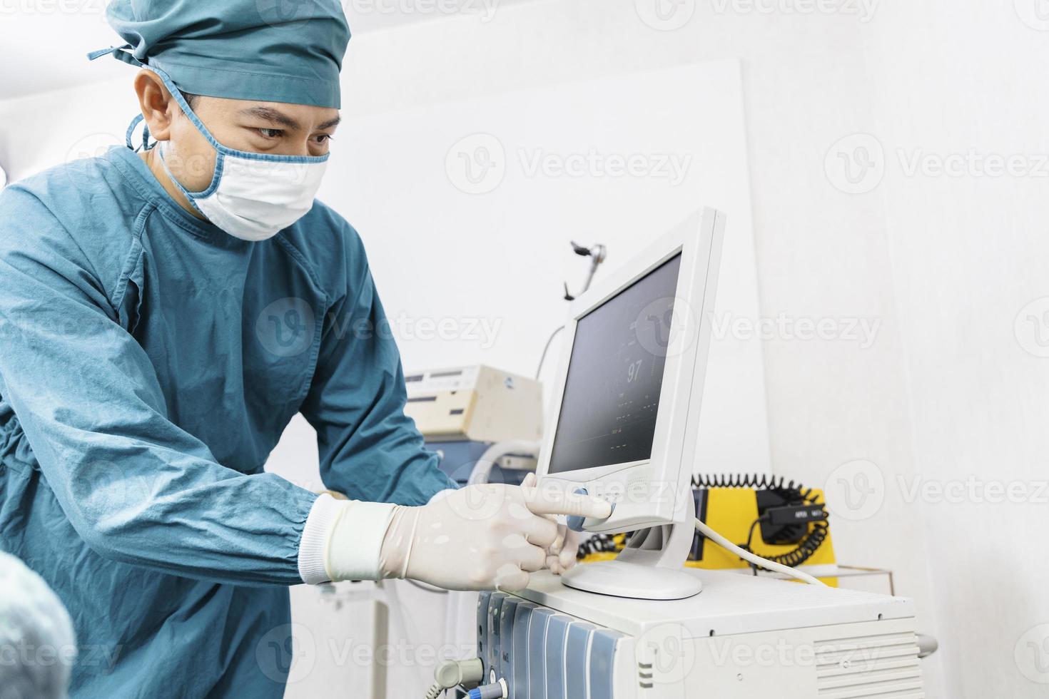 assistant surgeon put the patient on a ventilator-oxygen mask in preparation for surgery. photo