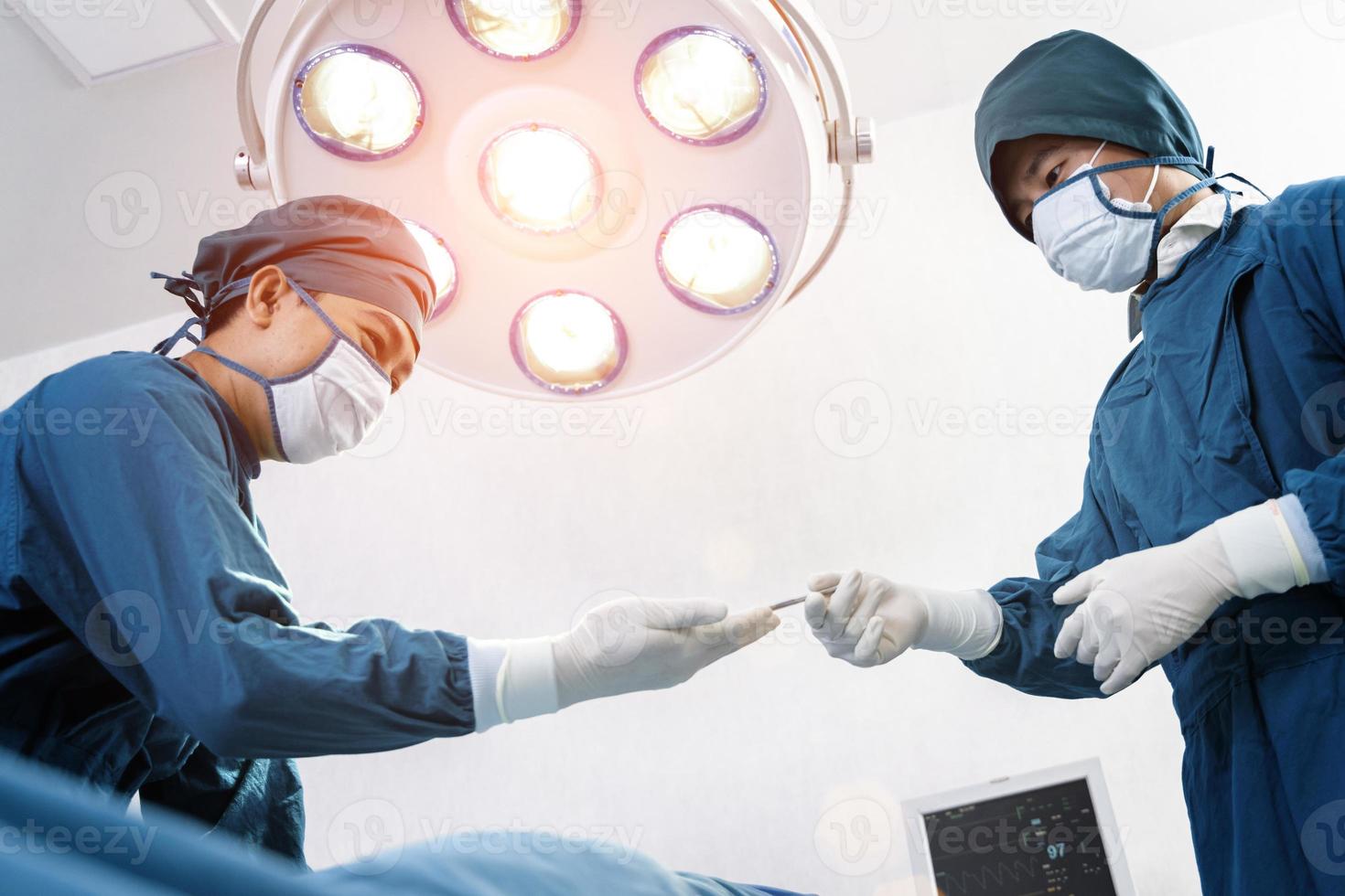 Assistant Hands out Instruments to Surgeons During Operation. Surgery and emergency concept photo