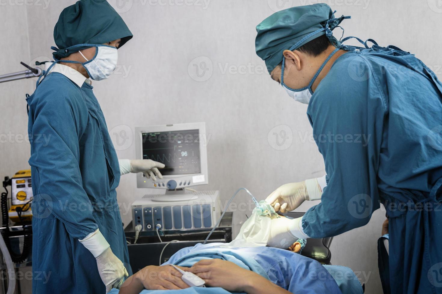 assistant surgeon put the patient on a ventilator-oxygen mask in preparation for surgery. photo