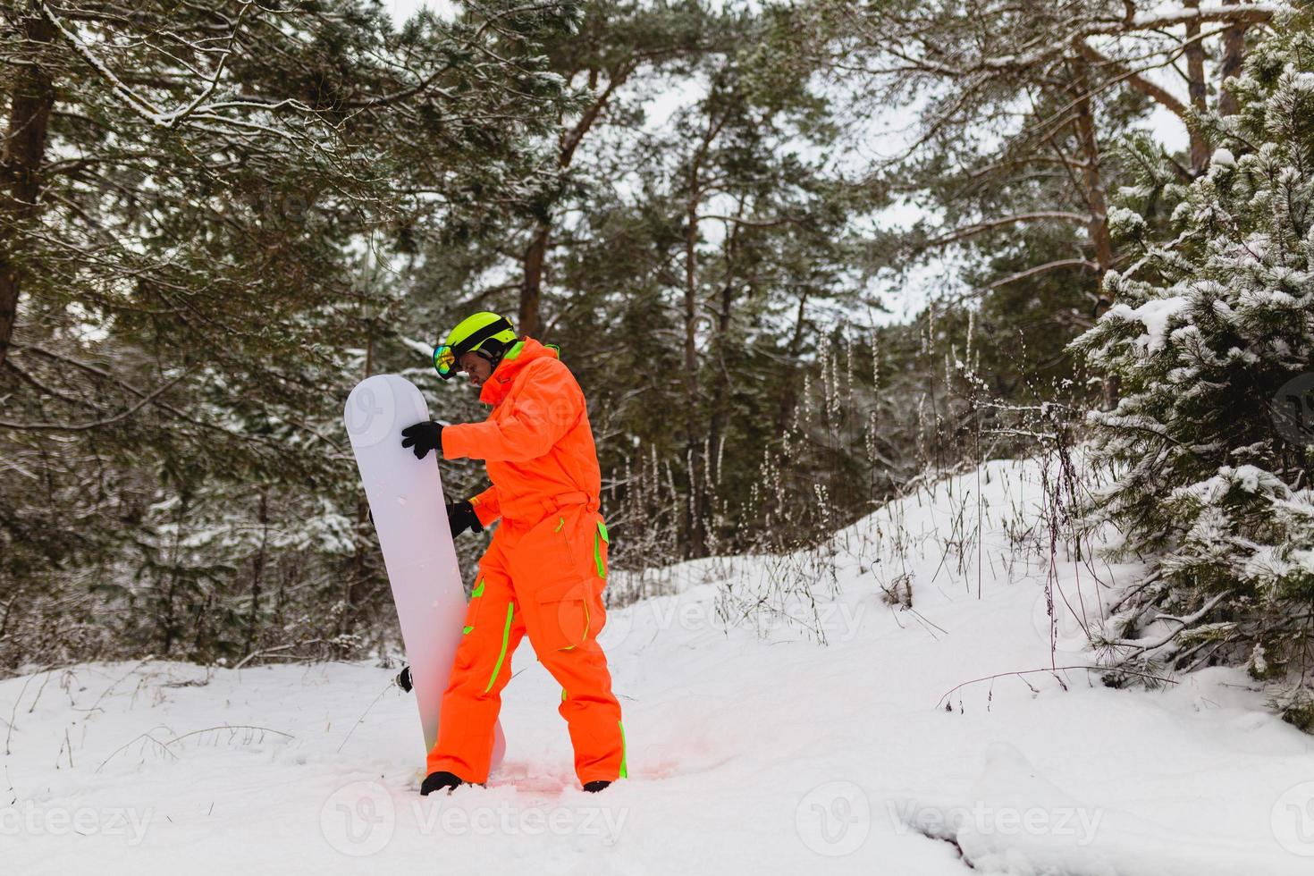 Snowboarder checks his equipment photo