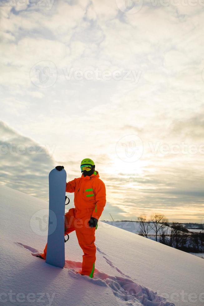 Snowboarder at the background of sunset photo