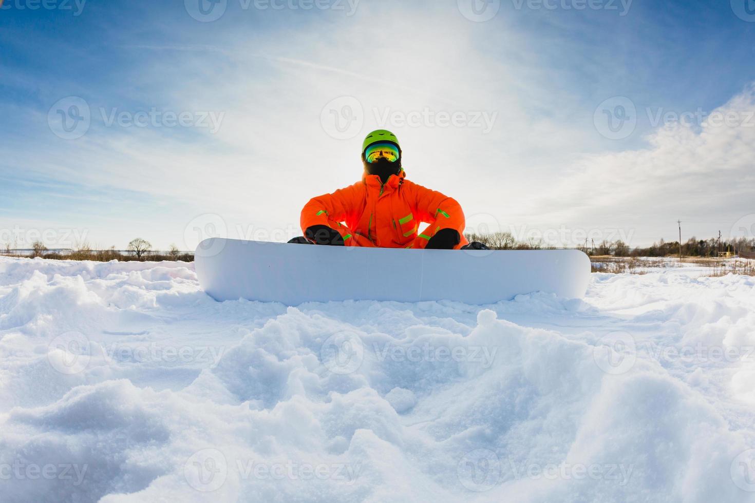 Snowboarder posing on the ski slope photo