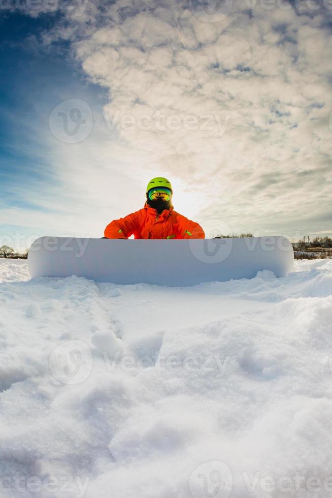 Snowboarder posing on the ski slope photo