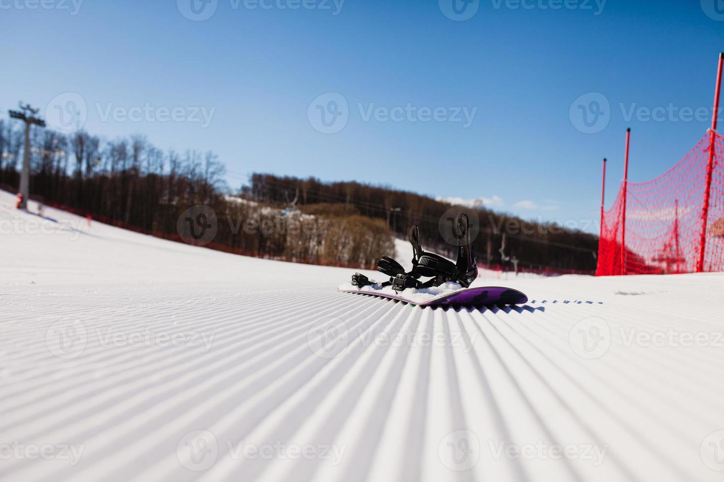 Bottom view on empty ski slope and equipment for snowboarding photo