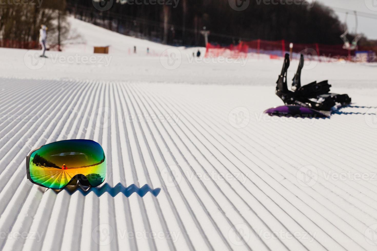 Equipment for snowboarding on a new groomed snow photo