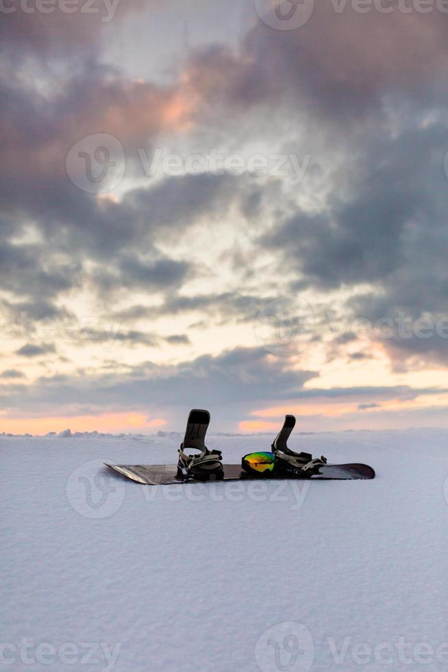 Powder texture and Equipment for snowboarding at sunset photo