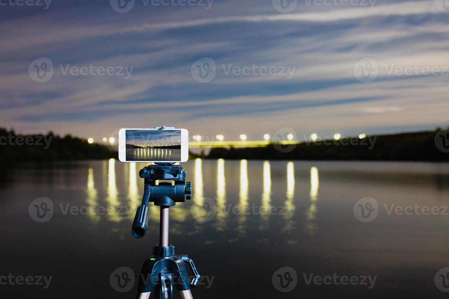 Using smartphone like professional camera on tripod to capturing night landscape photo