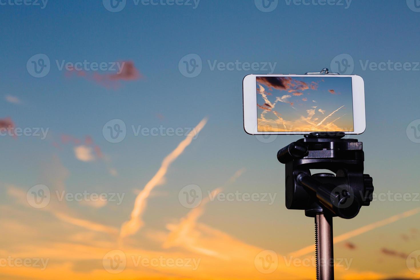 Smartphone on tripod capturing image of stunning sundown photo