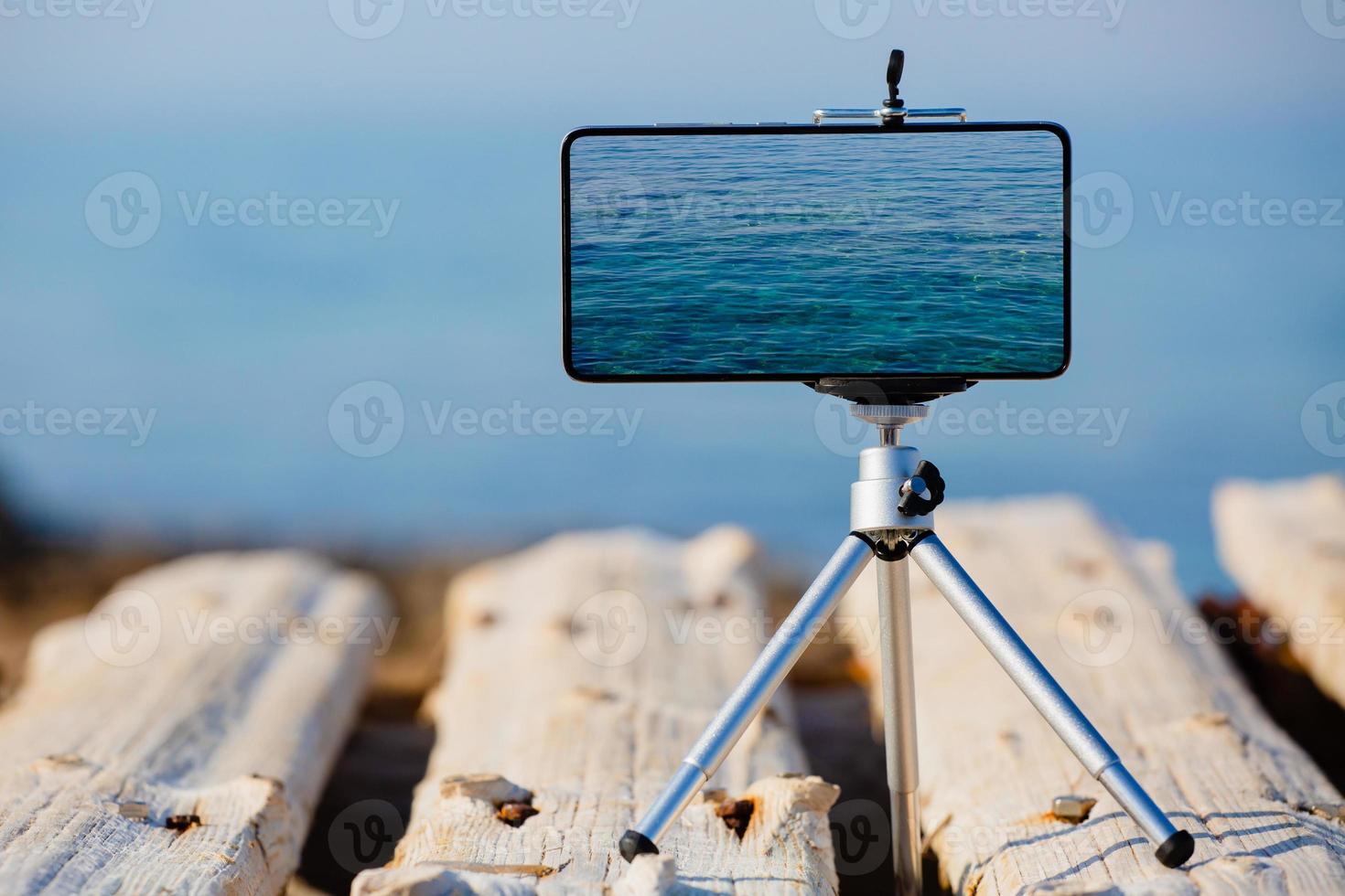 Smartphone on tripod making the pictures of the beautiful water surface photo