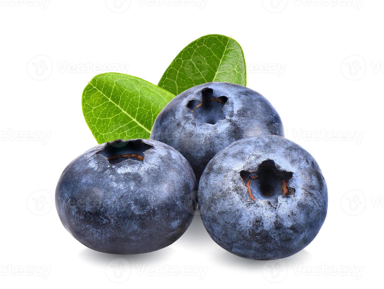 Blueberries with green leaves closeup, isolated on white background photo