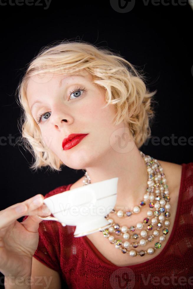 Beautiful Snobbish lady holding a cup of tea photo