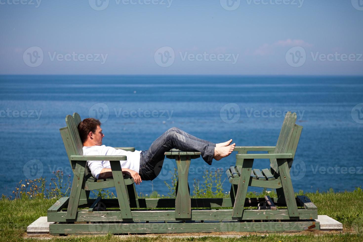 Young man sitting on the bench photo