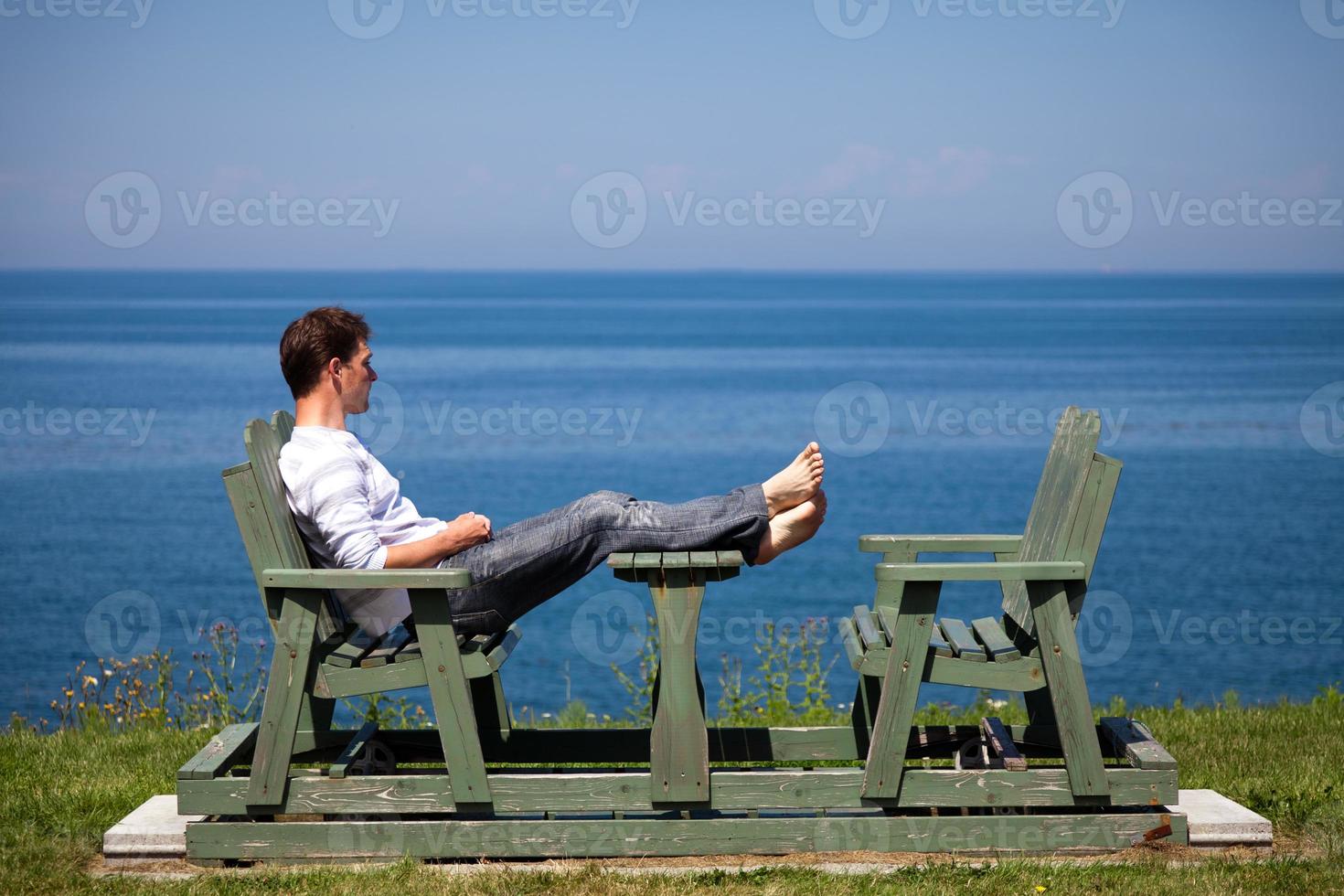 Young man sitting on the bench photo