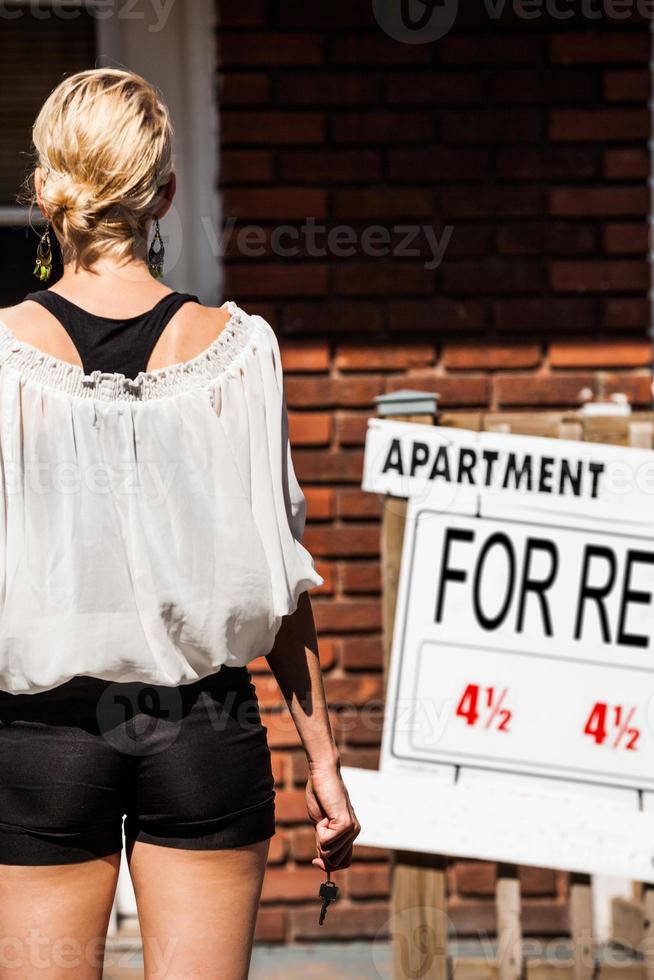 Young Woman standing in front of her new apartment photo