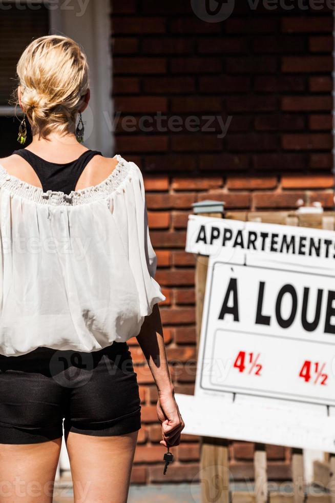 Young Woman standing in front of her new apartment photo