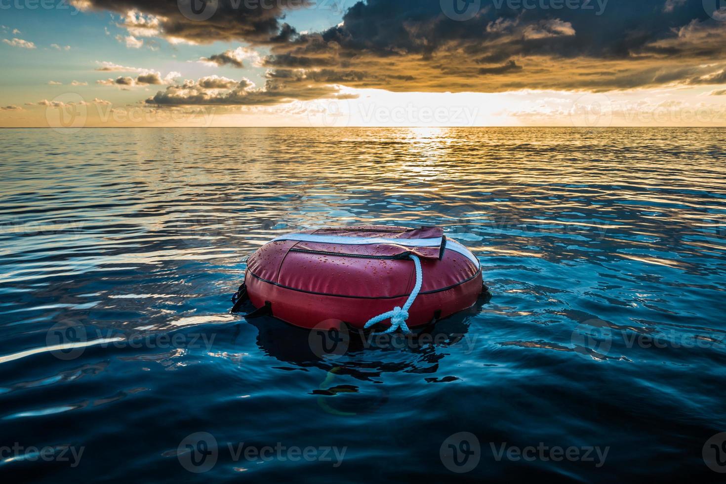 Red buoy for freediving floating in the ocean. photo