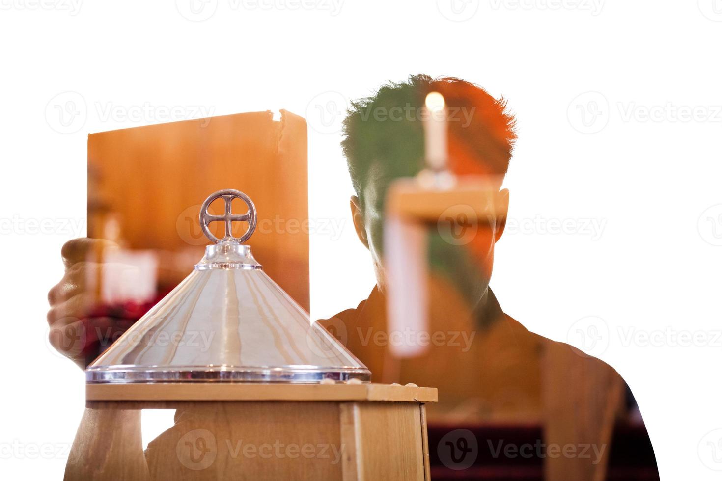 Man figure in silhouette showing a religious book photo