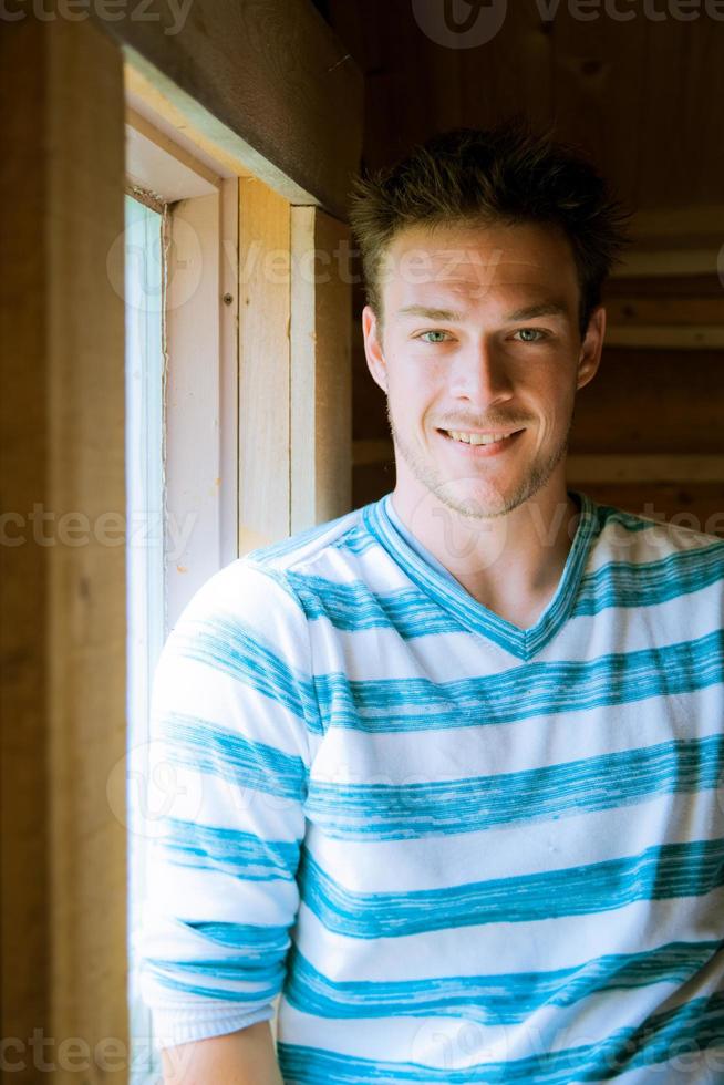 Young man at the window photo