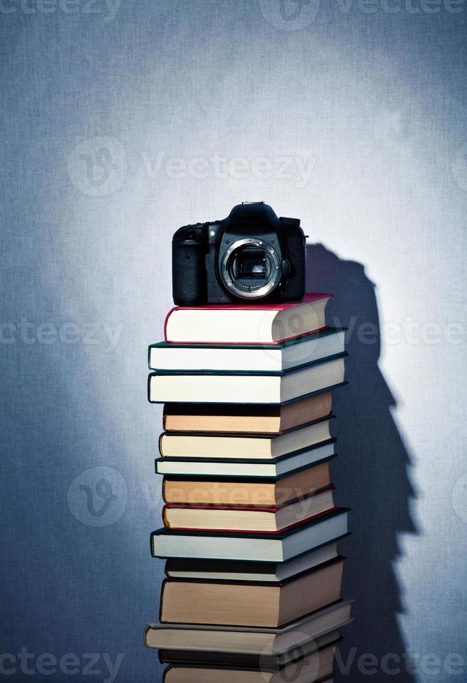 Camera on a high stack of books photo