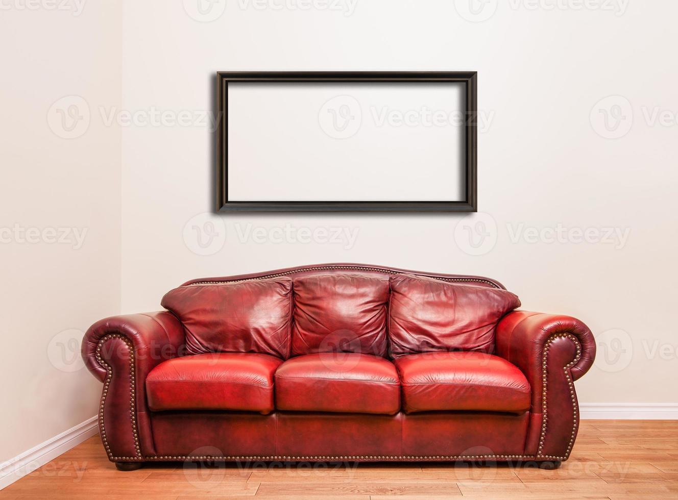 Luxurious Red Leather Couch in front of a blank wall photo