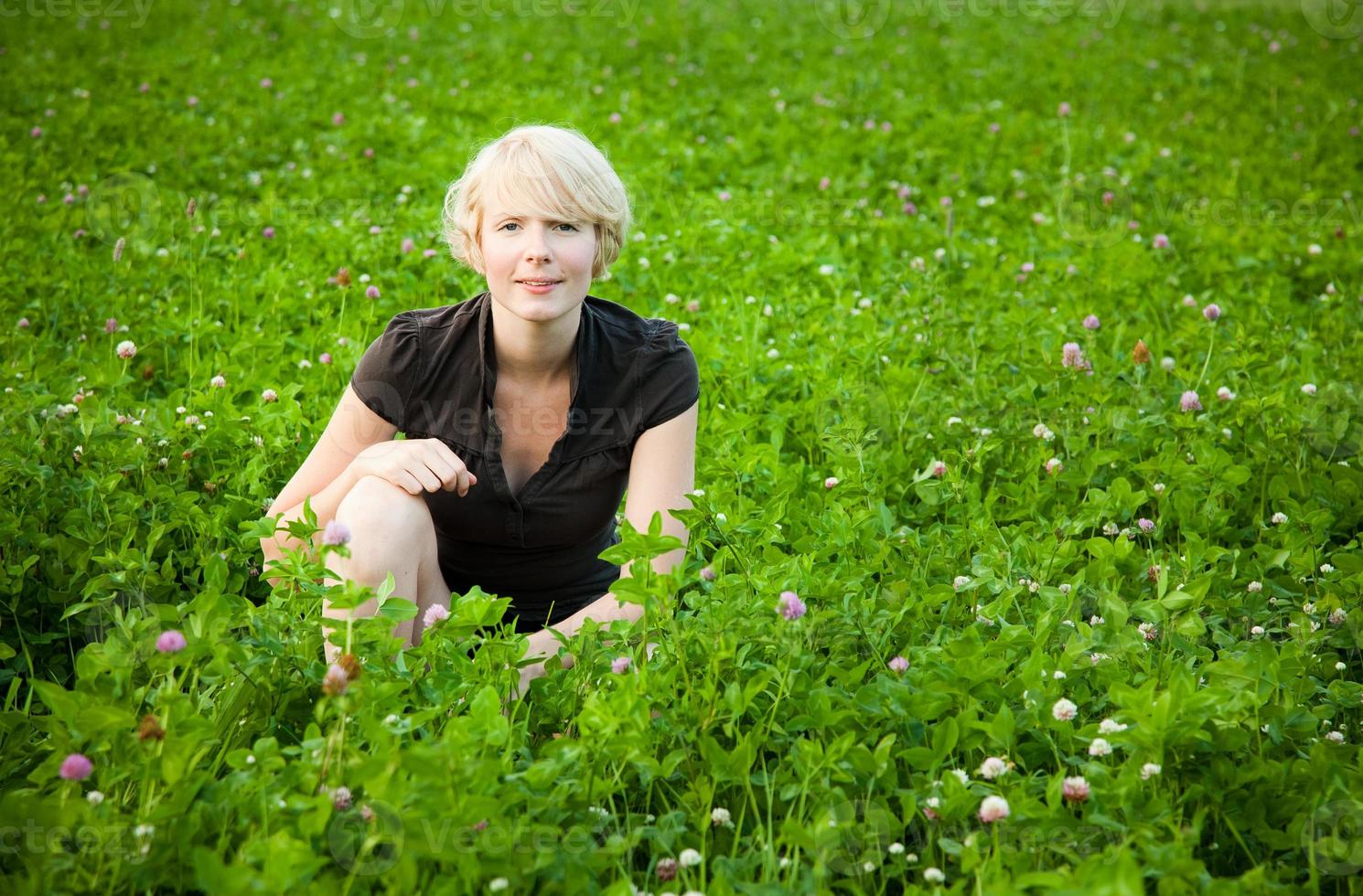 Girl in a field of flowers looking at the camera photo