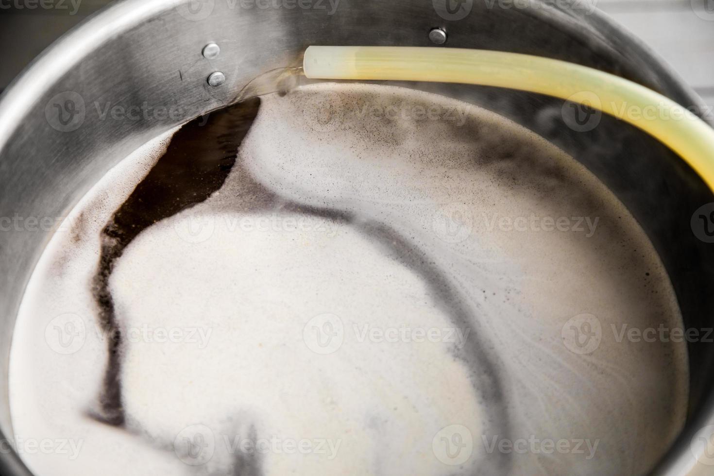 Pouring Craft Home Brew Beer Wort into the Boil Kettle photo