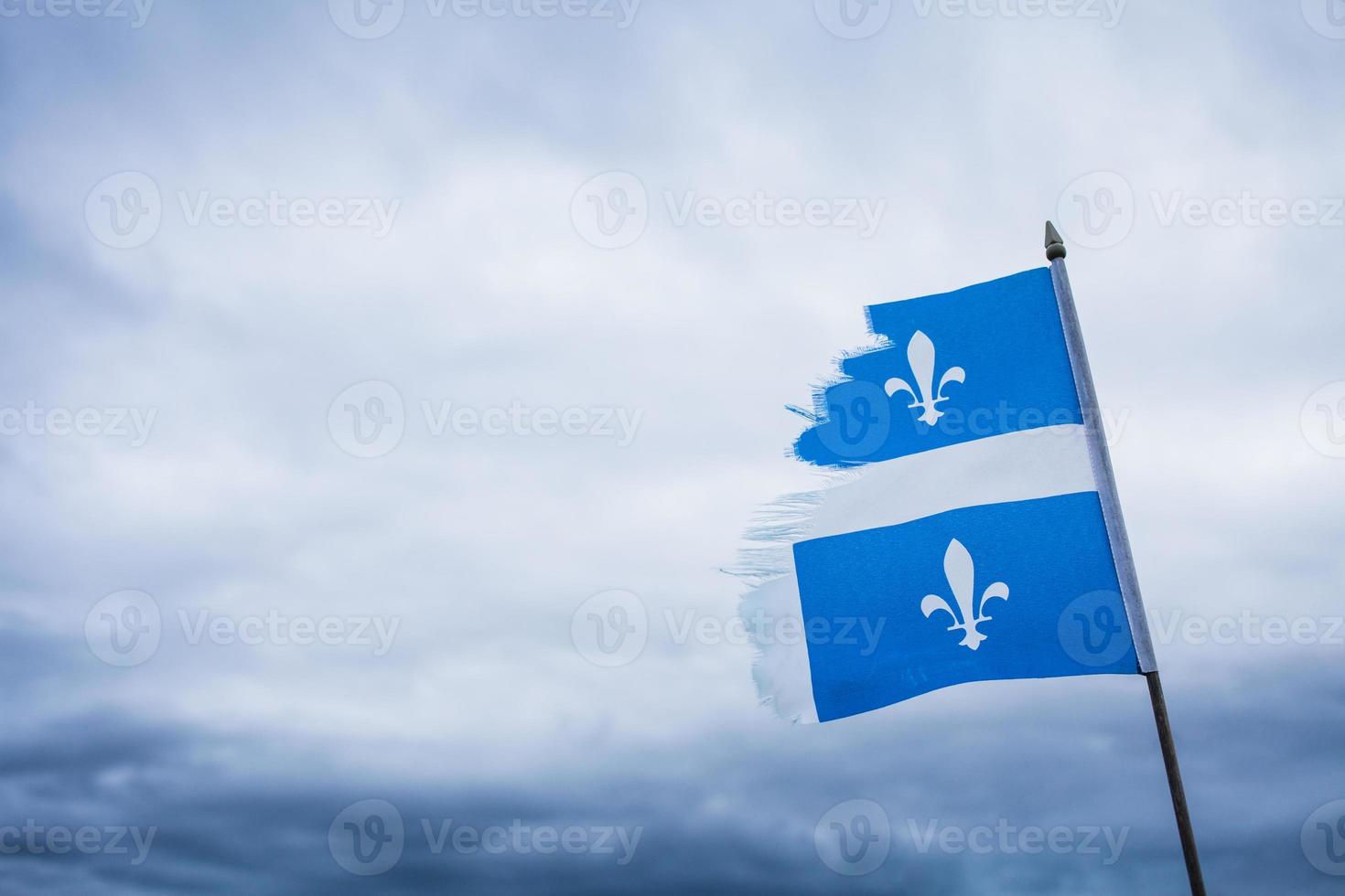 Metáfora con una bandera de Quebec rota y un cielo triste. foto