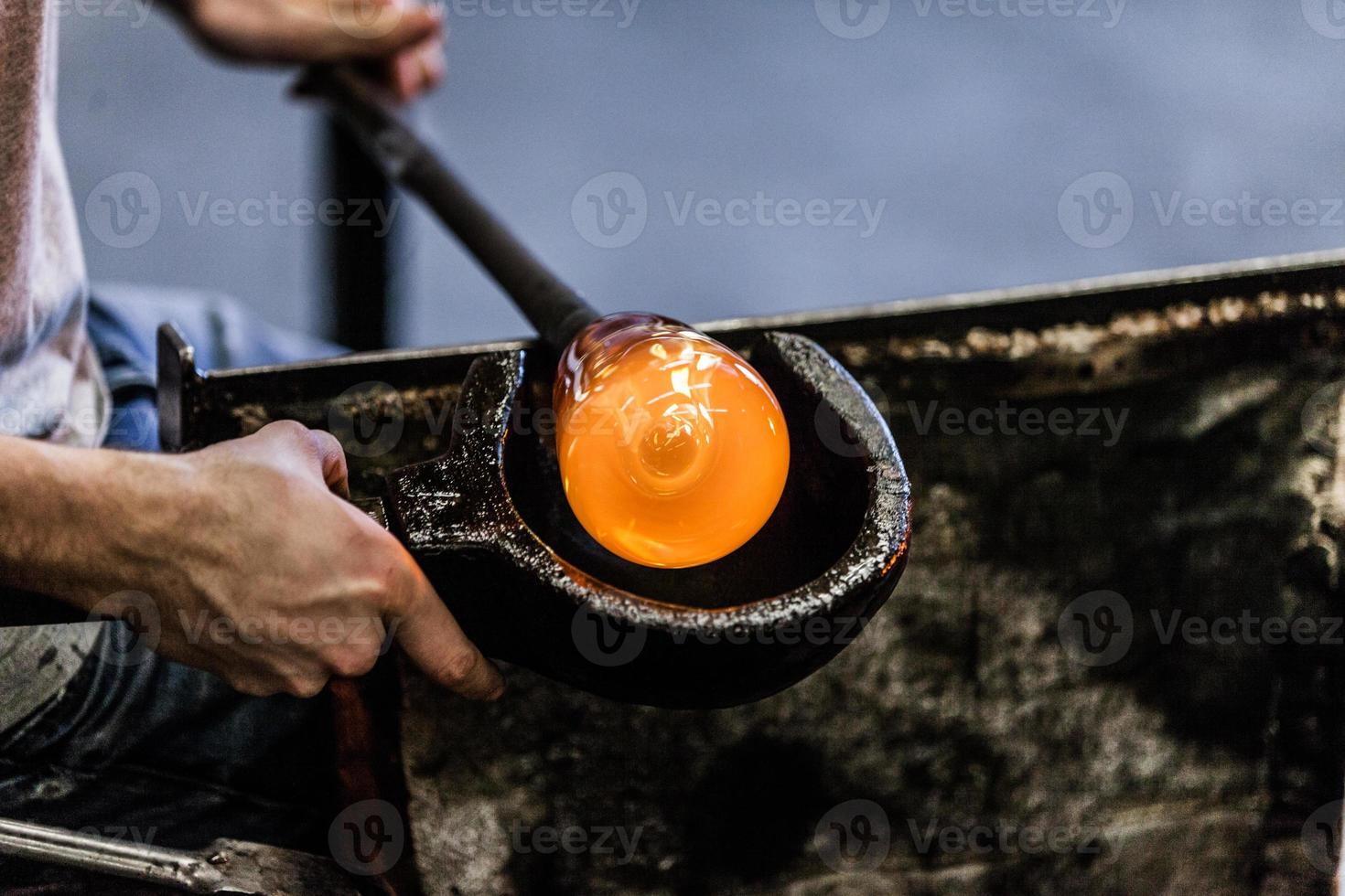 Man Hands Closeup Working on a Blown Glass Piece photo