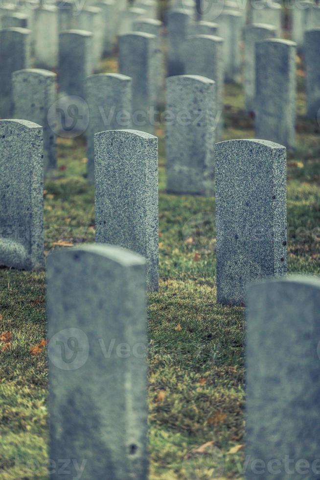 Back of Army Headstone and Graveyard Cemetery during a Sad Day of Autumn. photo