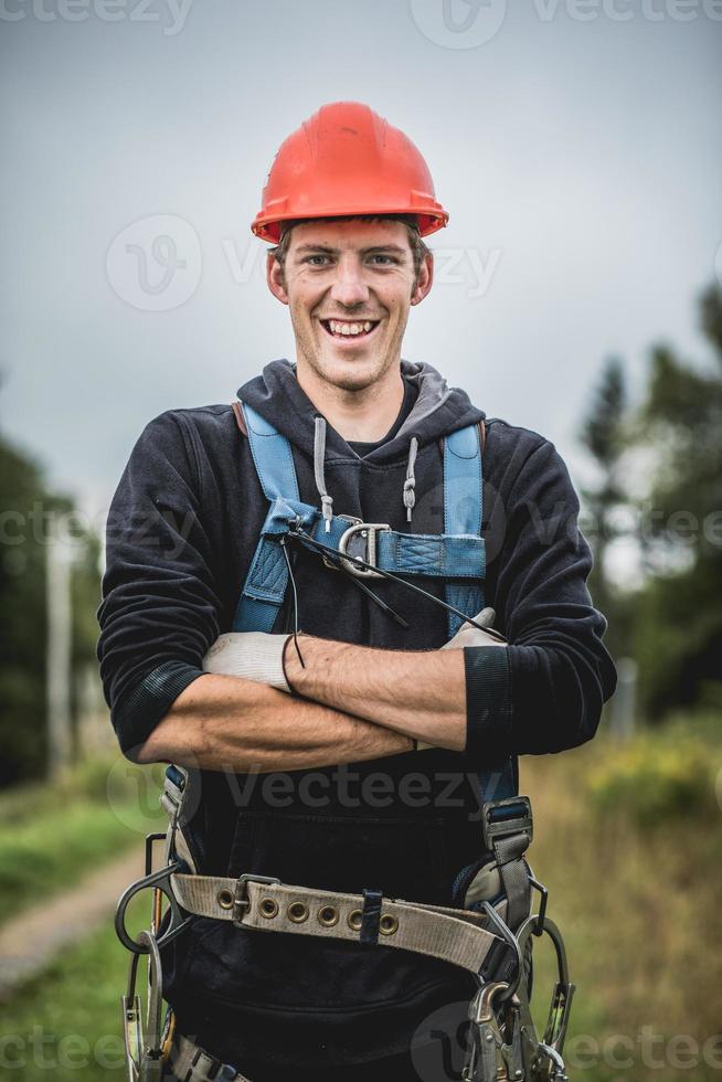 Telecom Technician man in uniform with harness photo