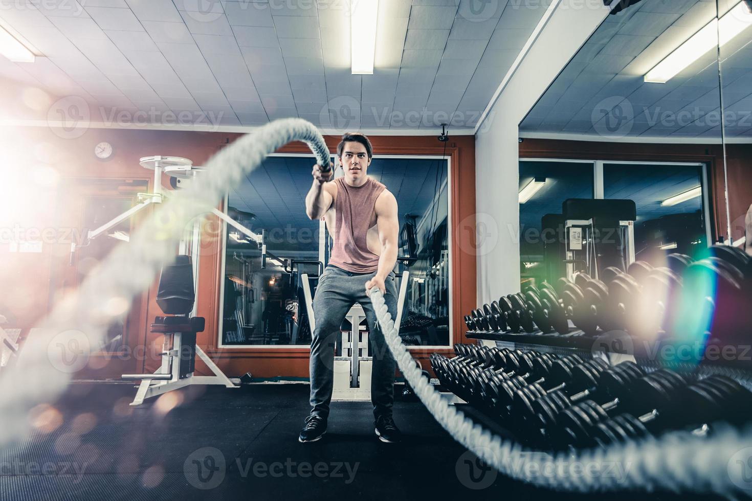 Man working out with battle ropes photo