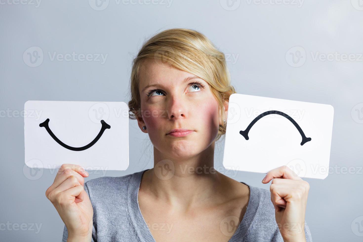 Portrait of a Person Holding Happy and Unhappy Mood Board photo