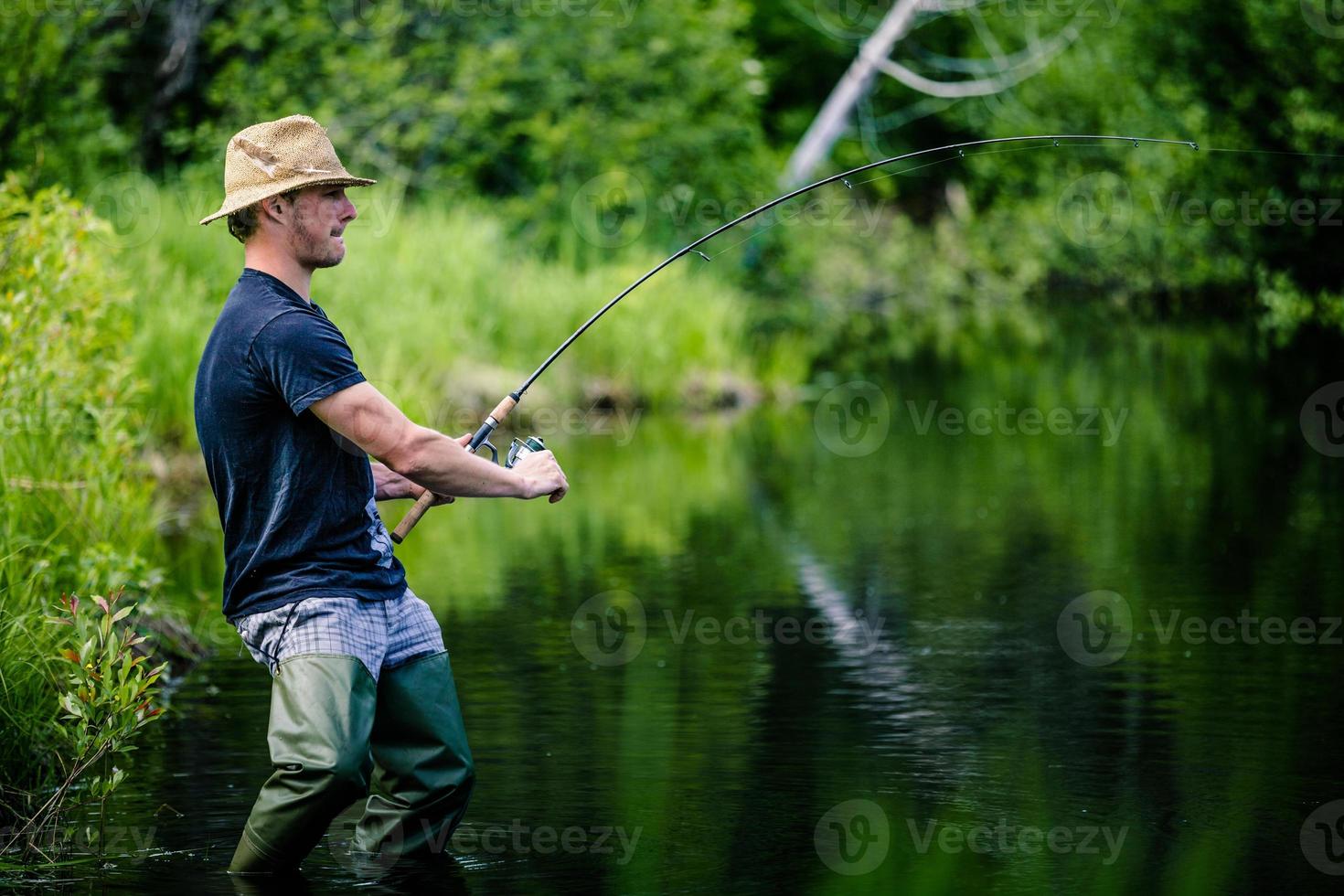 Young Fisherman Catching a big Fish photo