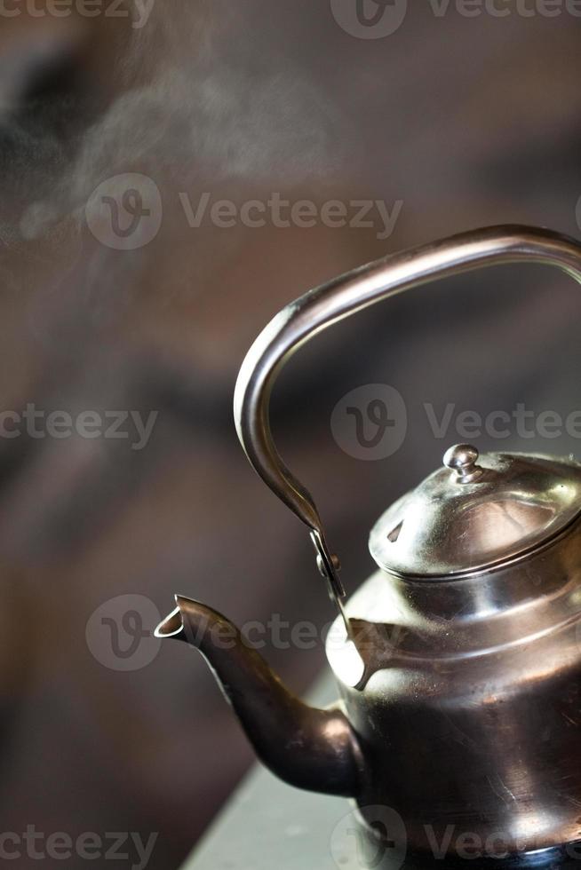 Boiling kettle on stove photo