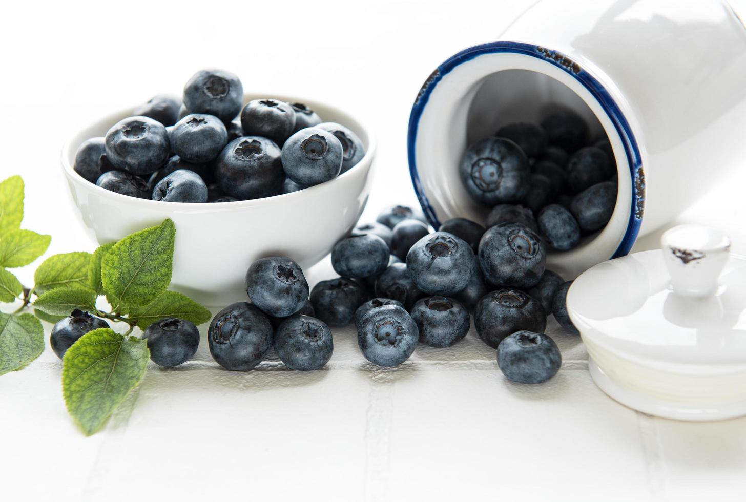 Blueberries on white tile  background photo