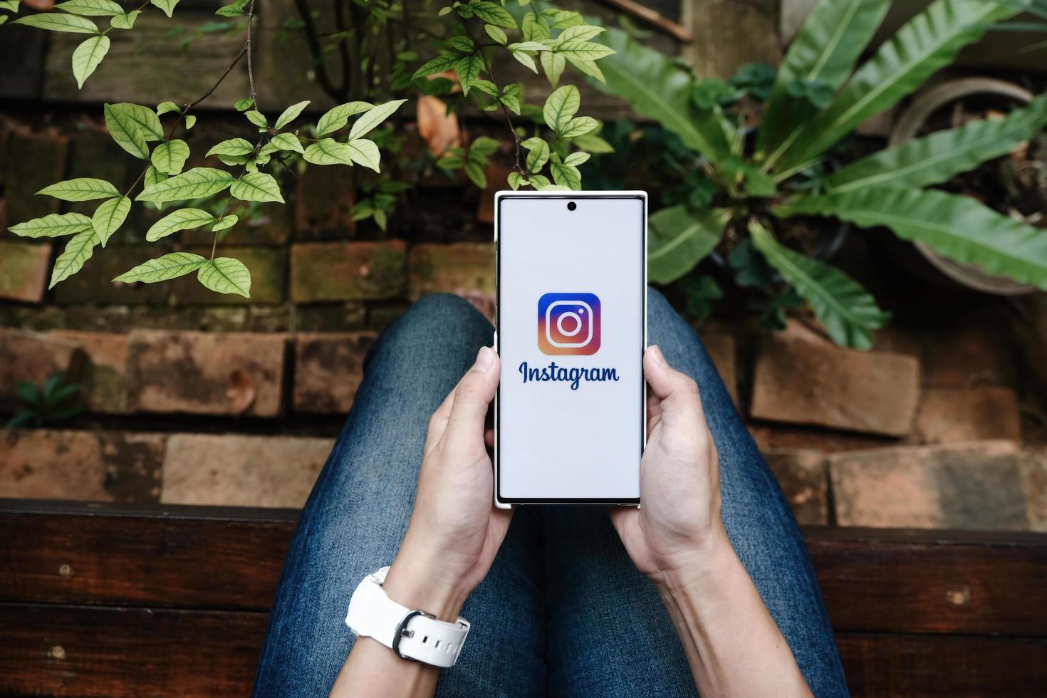 CHIANGMAI, THAILAND - July 09, 2021- A woman holding smartphone with Instagram application on the screen. Instagram is a photo sharing app for smartphones.