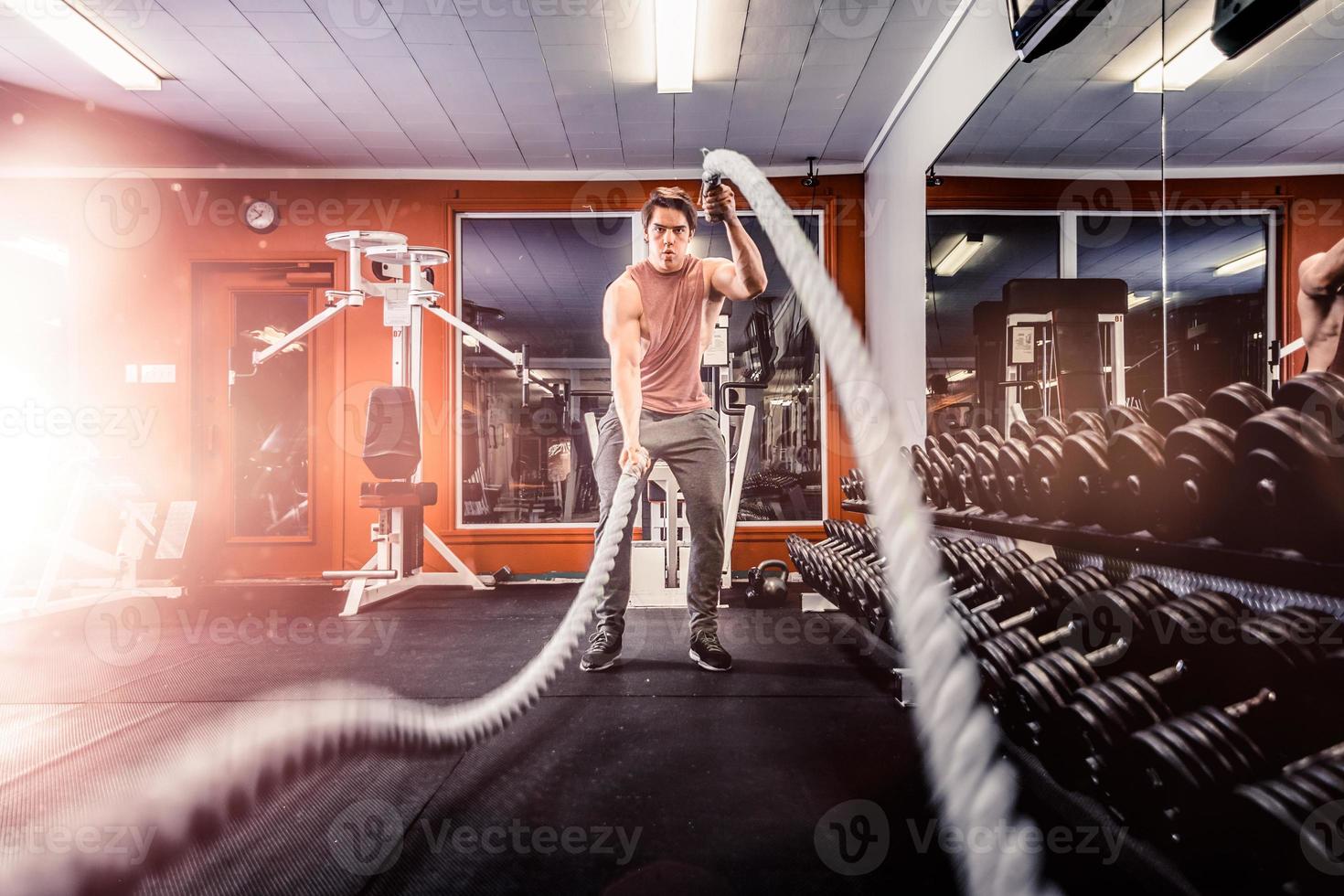 Man working out with battle ropes photo