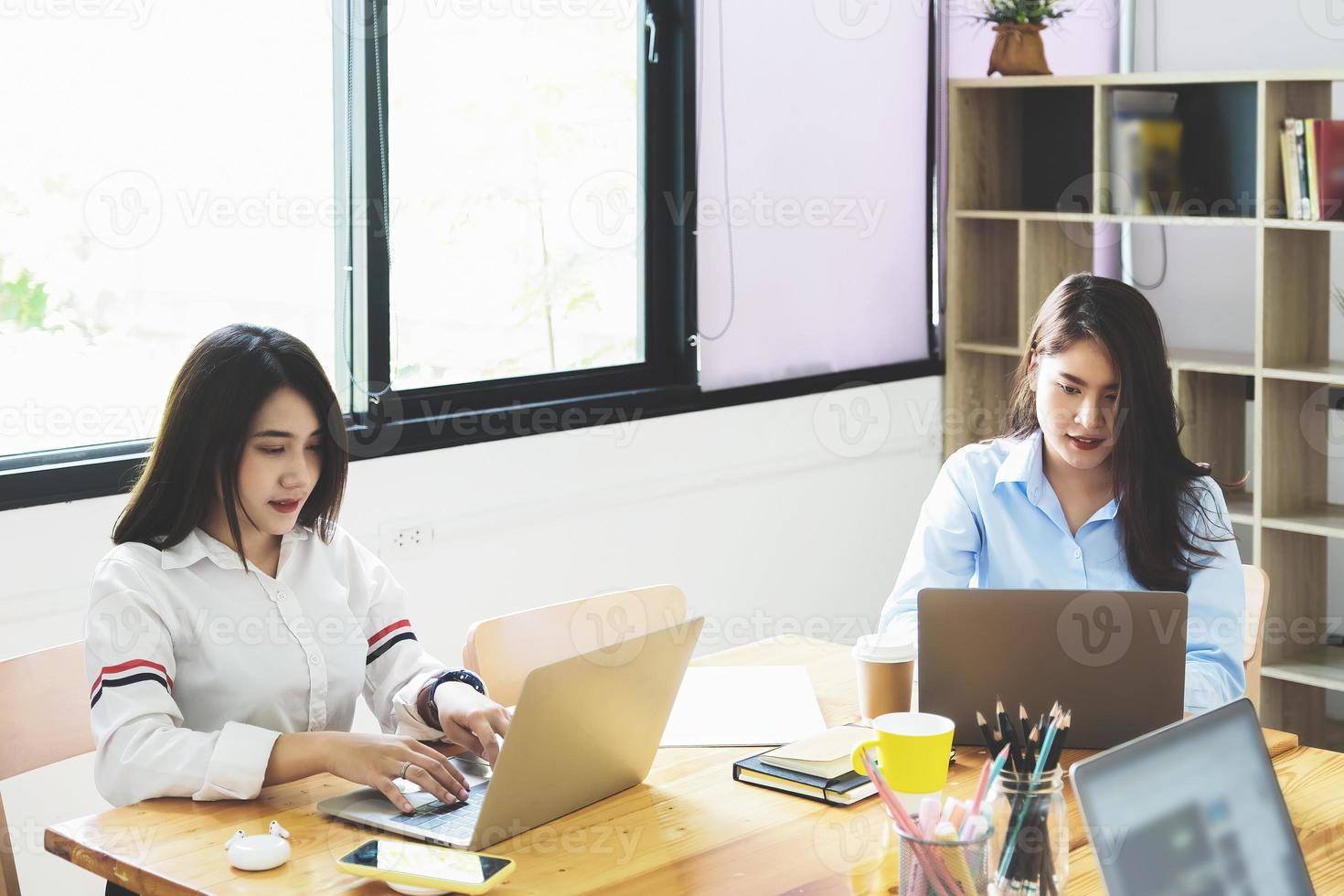 freelance concept, a group of female employees using computers to design work as ordered by customers photo