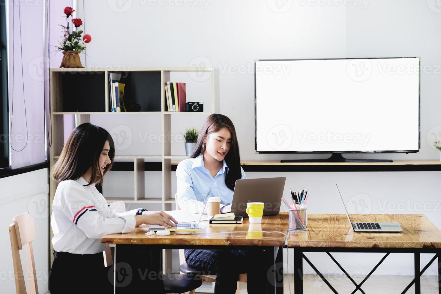 freelance concept, a group of female employees using computers to design work as ordered by customers. photo