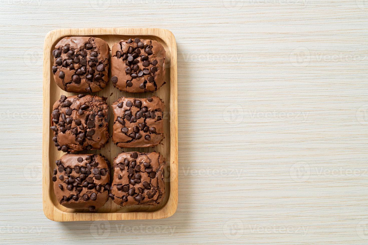 dark chocolate brownies topped by chocolate chips photo