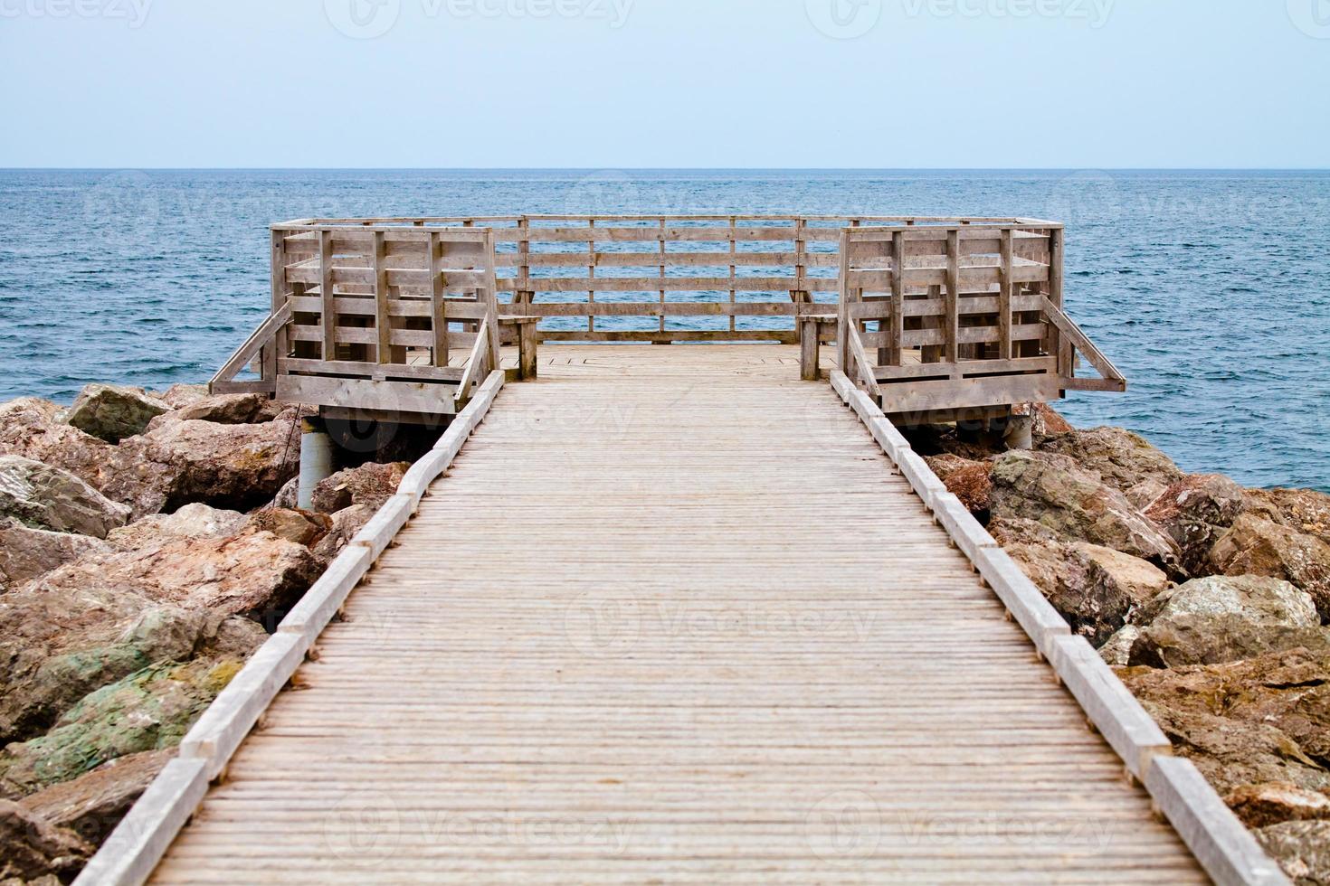 Long Wooden Dock with Observatory and View of the Ocean photo