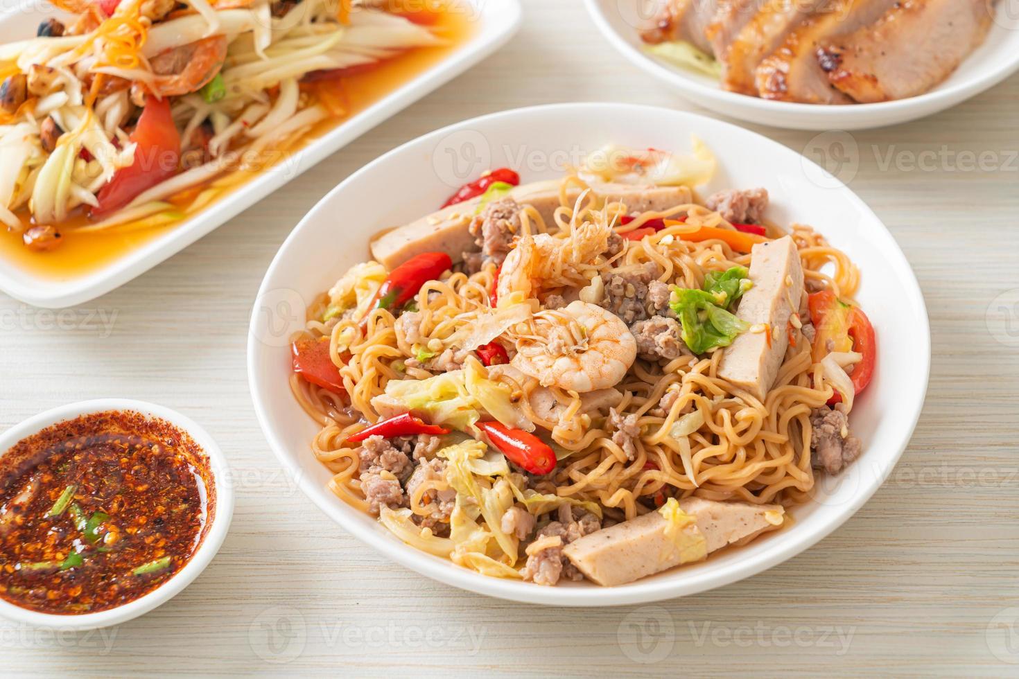 Instant noodles spicy salad on plate photo