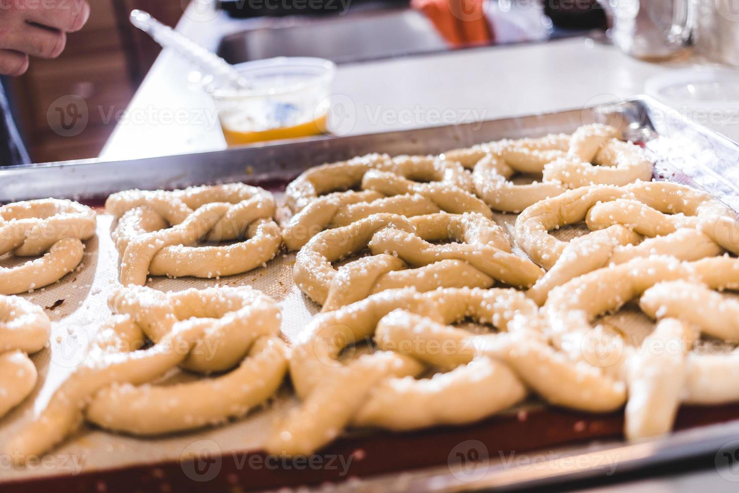 Salting pretzel ready to cook photo