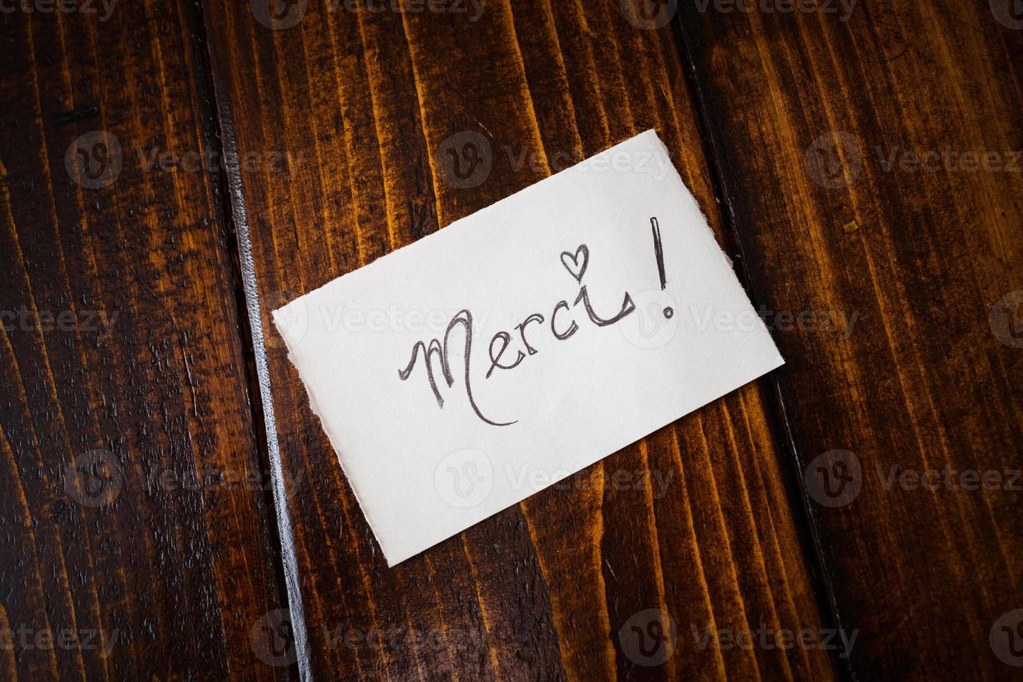 Thank You note in French on a Table photo