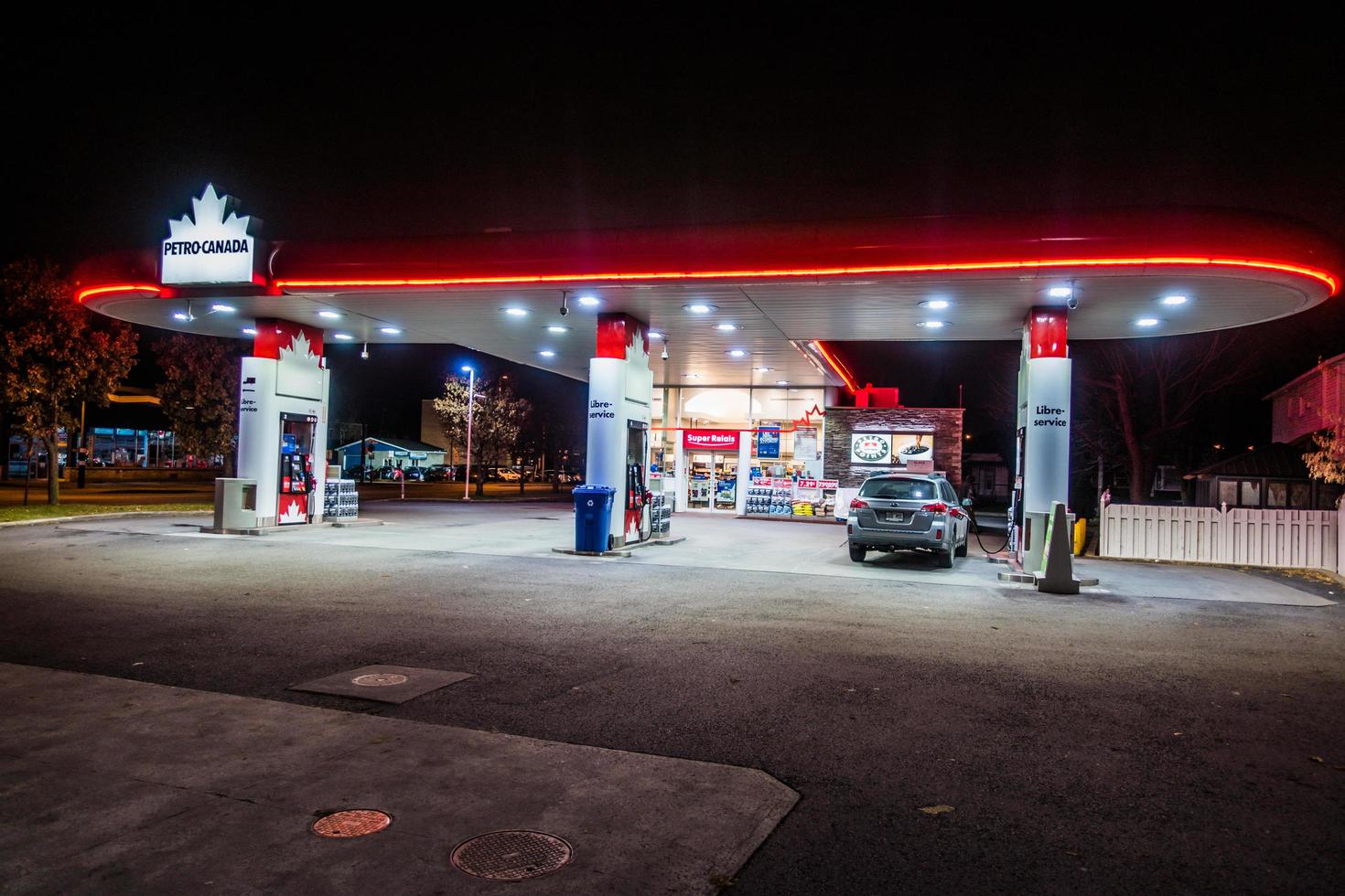 Montreal, Canada December 1, 2017. Petro Canada Commerce and Gas Station Illuminated Late at Night photo