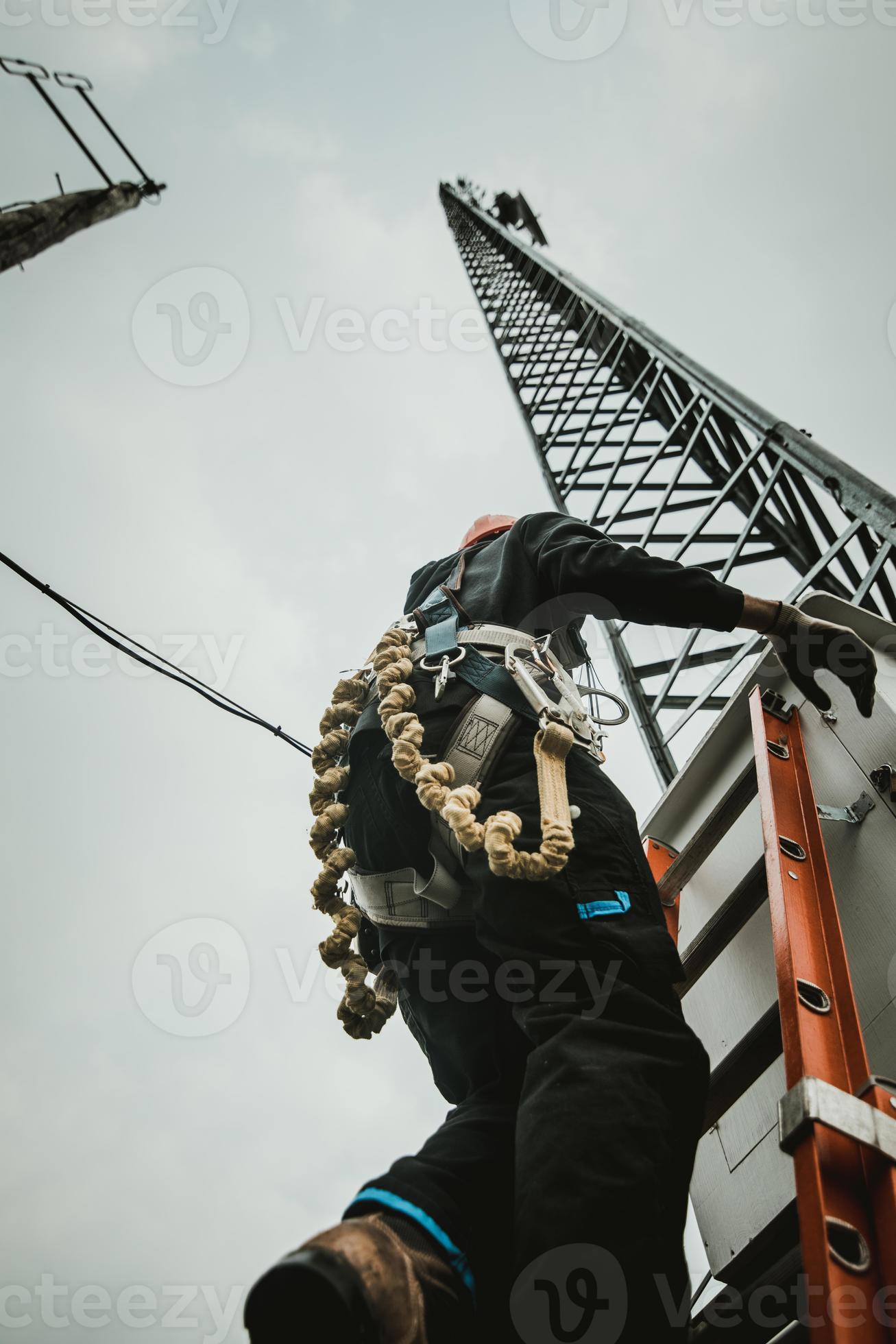 Worker Climbing Antenna Tower 4304243 Stock Photo at Vecteezy