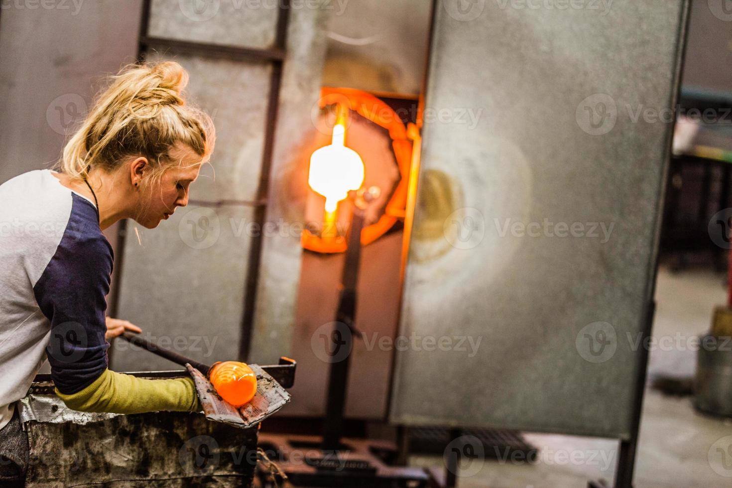 Blowing Glass Professional Woman Working on a Vase. photo